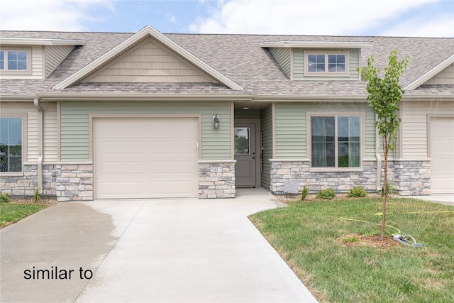 view of front of house featuring a garage and a front lawn