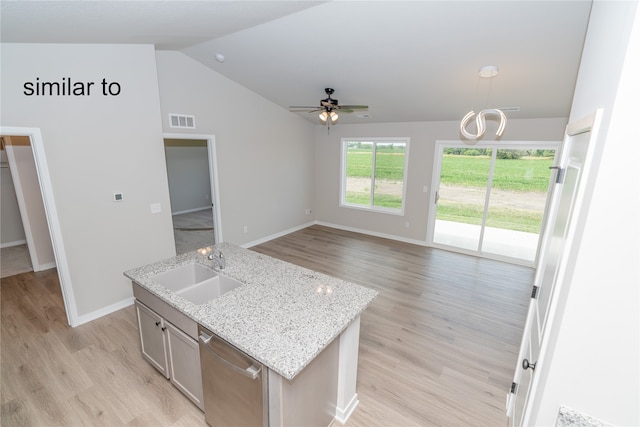 kitchen with lofted ceiling, an island with sink, light wood-type flooring, sink, and decorative light fixtures