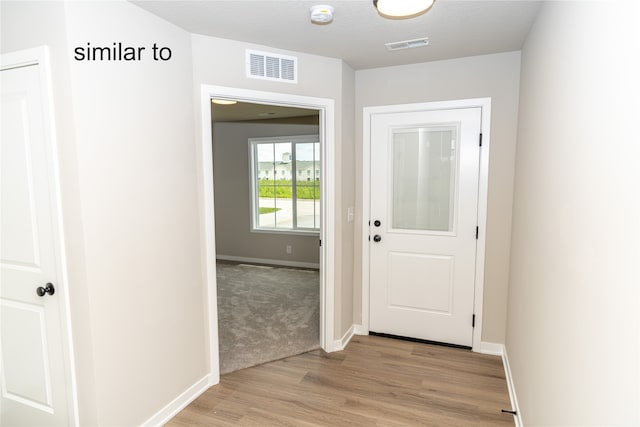 doorway with light hardwood / wood-style flooring