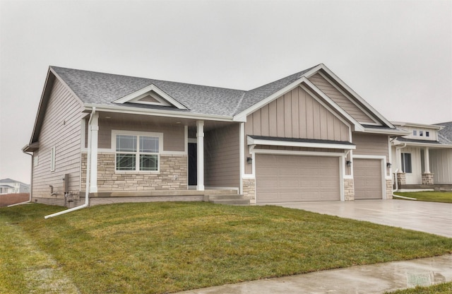 view of front of house featuring a garage and a front lawn