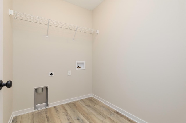 laundry area with baseboards, laundry area, electric dryer hookup, washer hookup, and light wood-style floors