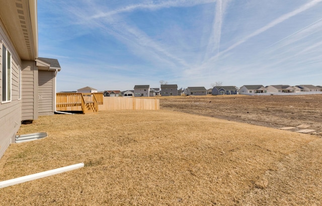 view of yard with a residential view and a deck