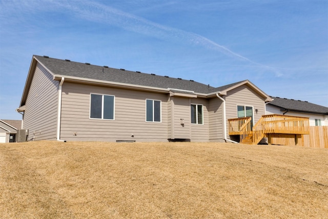 back of property featuring stairway, central AC unit, a deck, and roof with shingles