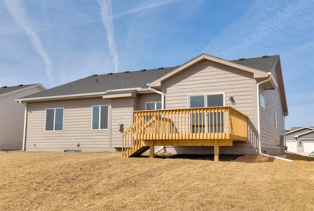 rear view of property featuring a deck, a yard, roof with shingles, and crawl space