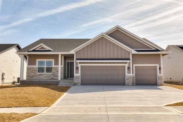 craftsman-style house with driveway, a shingled roof, a garage, and board and batten siding