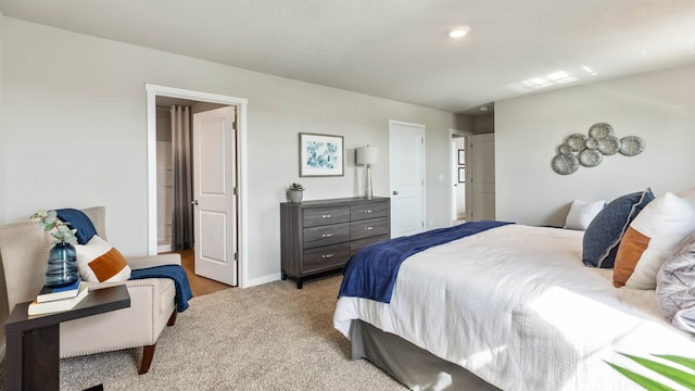 bedroom featuring light colored carpet and baseboards