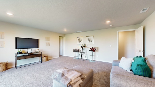 living room with light colored carpet and a textured ceiling