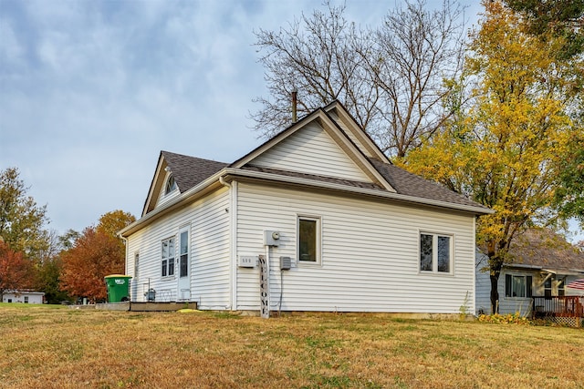 view of side of home featuring a lawn