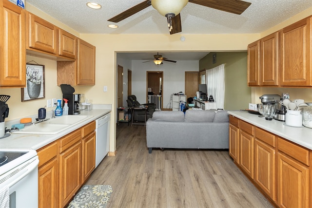 kitchen with light hardwood / wood-style floors, a textured ceiling, ceiling fan, and white appliances