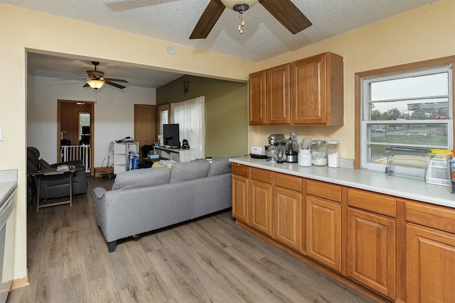 kitchen featuring a textured ceiling, light wood-type flooring, and ceiling fan