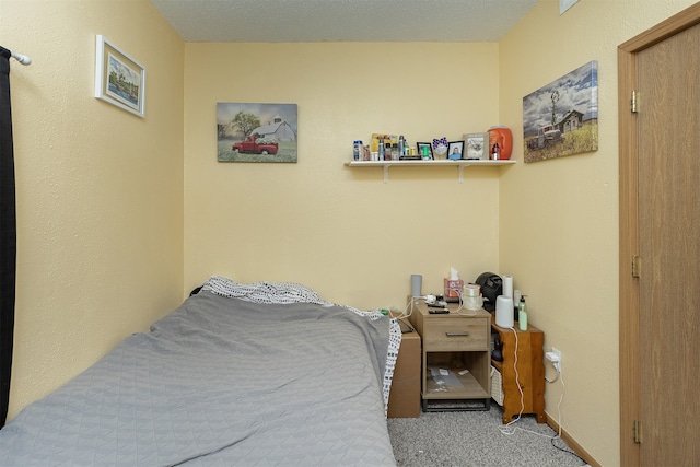 bedroom with a textured ceiling and carpet flooring