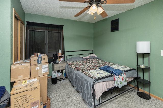 carpeted bedroom featuring a textured ceiling and ceiling fan