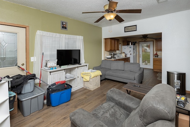 living room featuring hardwood / wood-style floors, a textured ceiling, and ceiling fan