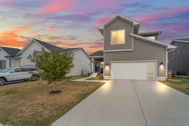 view of front of home featuring a lawn and a garage