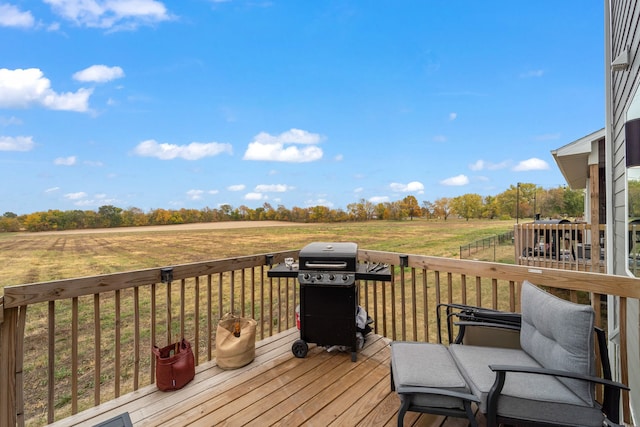 wooden terrace featuring a rural view and a grill