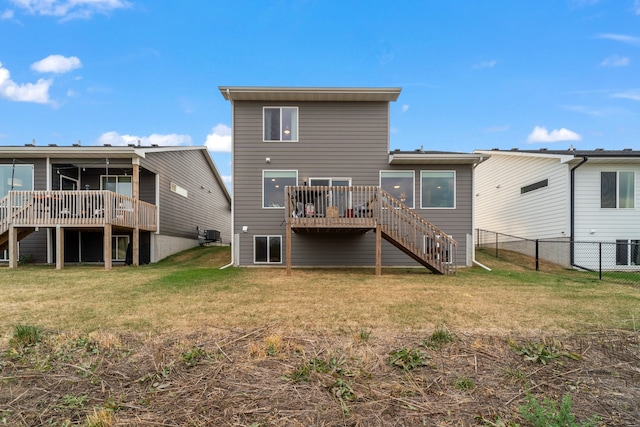 back of property with a yard, a wooden deck, and central air condition unit