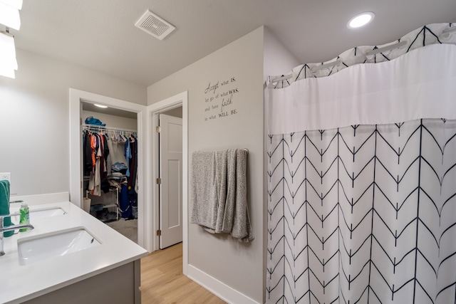 bathroom featuring vanity, hardwood / wood-style floors, and curtained shower