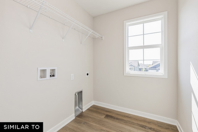 clothes washing area featuring hookup for a washing machine, hardwood / wood-style floors, and electric dryer hookup