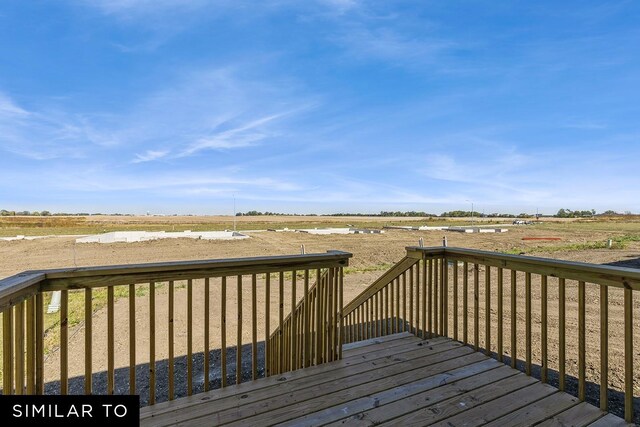 wooden deck featuring a rural view