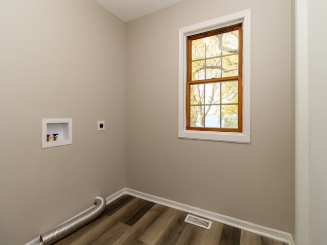 clothes washing area featuring hookup for an electric dryer, washer hookup, and dark wood-type flooring