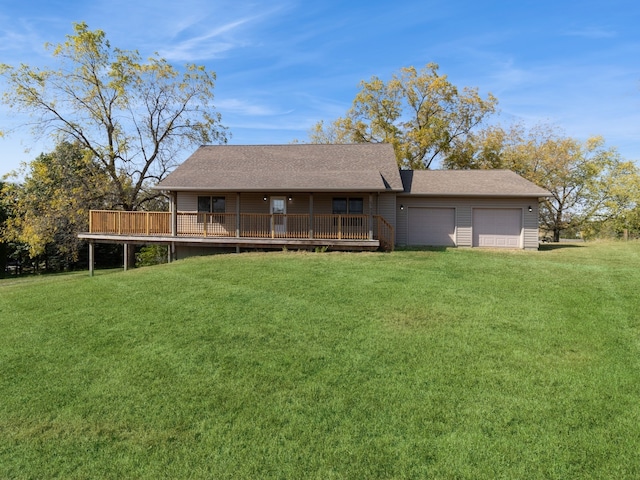 view of front of house featuring a front lawn, a deck, and a garage