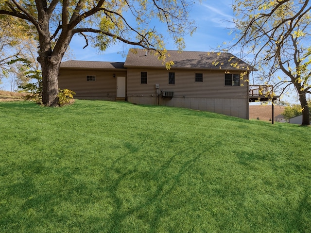 back of property with a yard and a deck