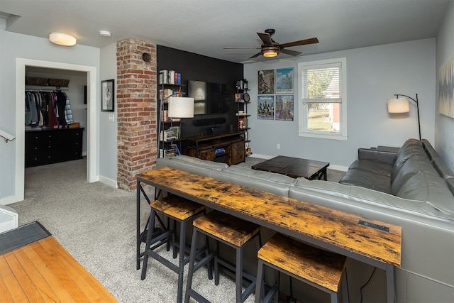 living room featuring ceiling fan and light colored carpet