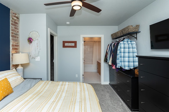 carpeted bedroom with ceiling fan and ensuite bath