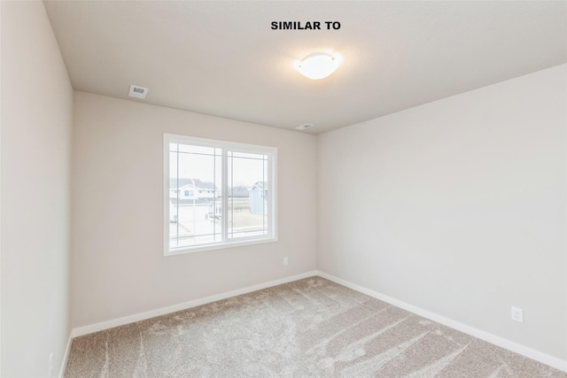 carpeted spare room with baseboards and visible vents