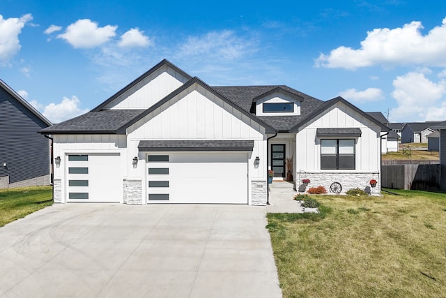 modern inspired farmhouse featuring a front lawn and a garage