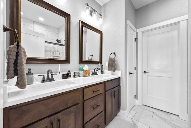 bathroom with vanity and a shower with shower door