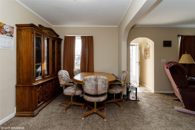 dining room featuring crown molding and light colored carpet