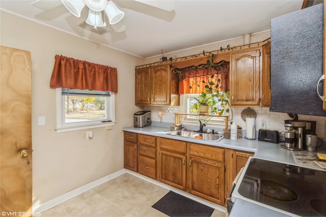 kitchen featuring backsplash, white stove, sink, and ceiling fan