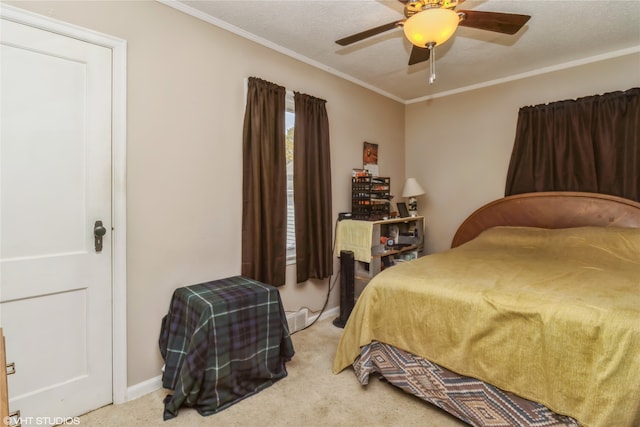 carpeted bedroom featuring ornamental molding, a textured ceiling, and ceiling fan