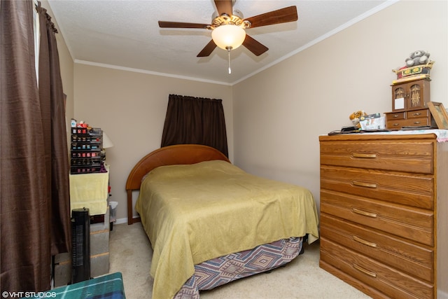 carpeted bedroom featuring ceiling fan, crown molding, and a textured ceiling