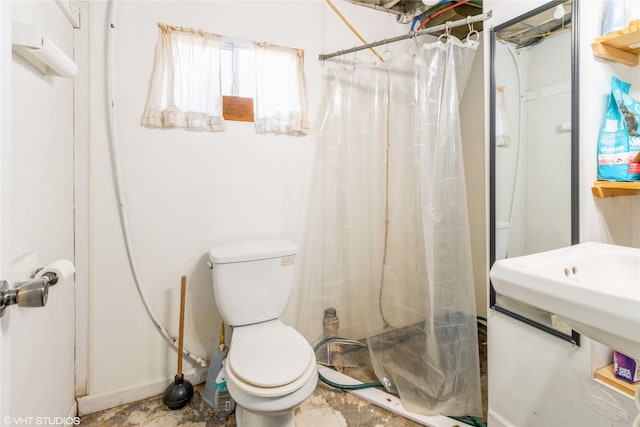 bathroom with toilet and a shower with curtain