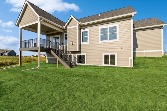 back of house featuring a yard and ceiling fan