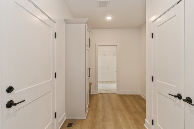 hall with light hardwood / wood-style floors