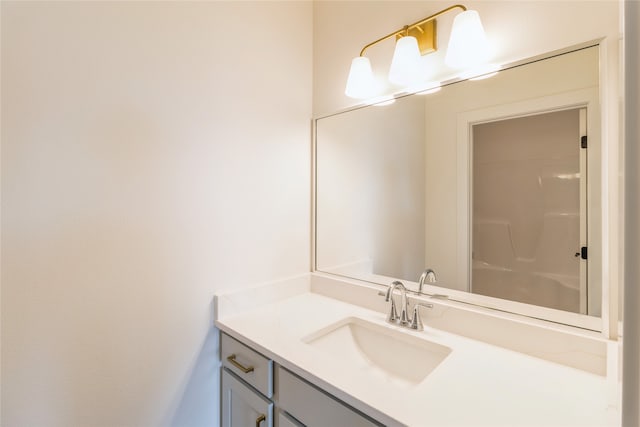 bathroom with vanity and a shower