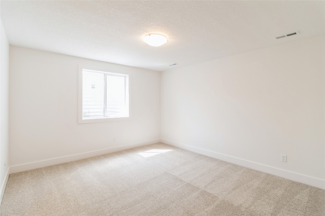 unfurnished room featuring a textured ceiling and carpet floors