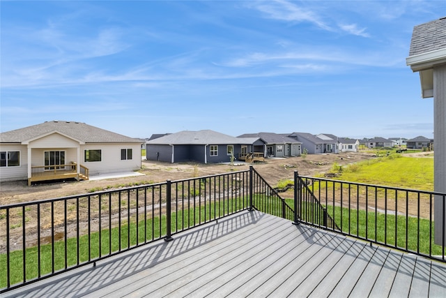 wooden terrace featuring a lawn