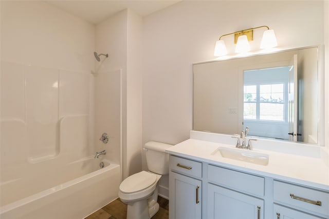 full bathroom featuring vanity, washtub / shower combination, wood-type flooring, and toilet