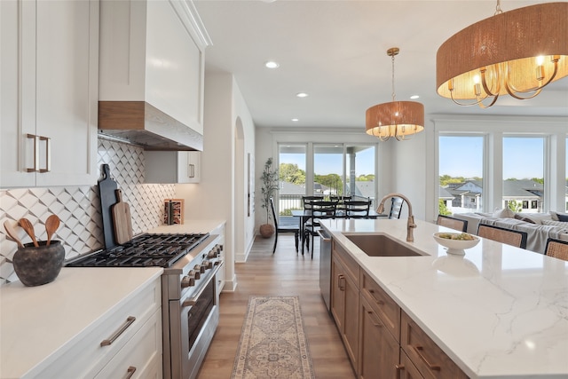 kitchen with a healthy amount of sunlight, stainless steel appliances, sink, and pendant lighting