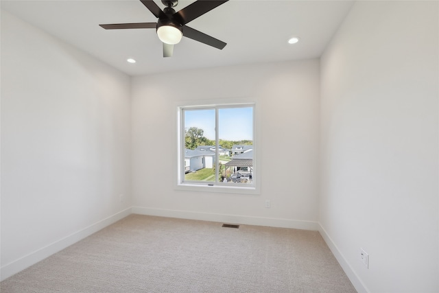 spare room featuring carpet floors and ceiling fan