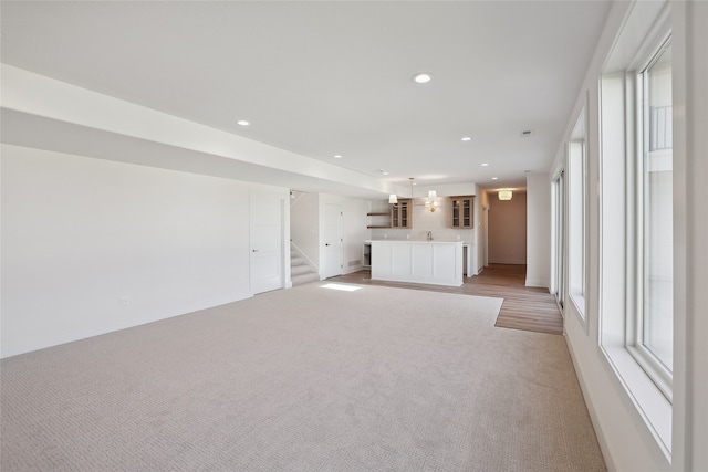 unfurnished living room with light carpet