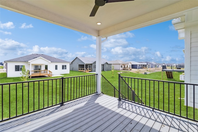 deck with a lawn and ceiling fan