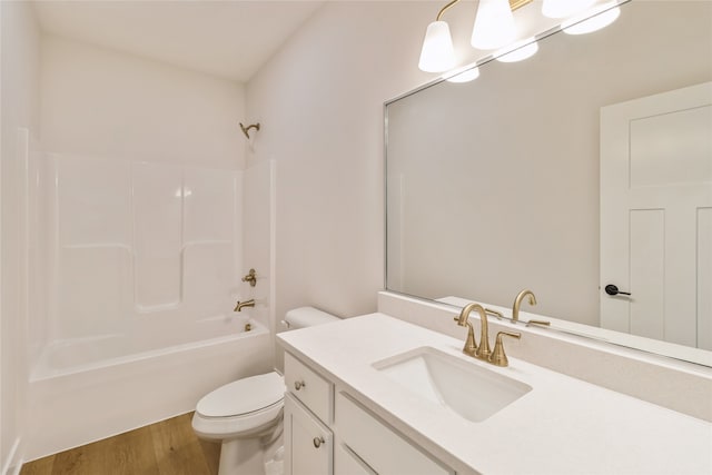 full bathroom featuring vanity, tub / shower combination, hardwood / wood-style floors, and toilet