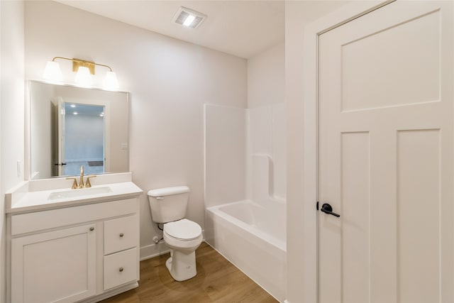 full bathroom with vanity, hardwood / wood-style floors, shower / washtub combination, and toilet