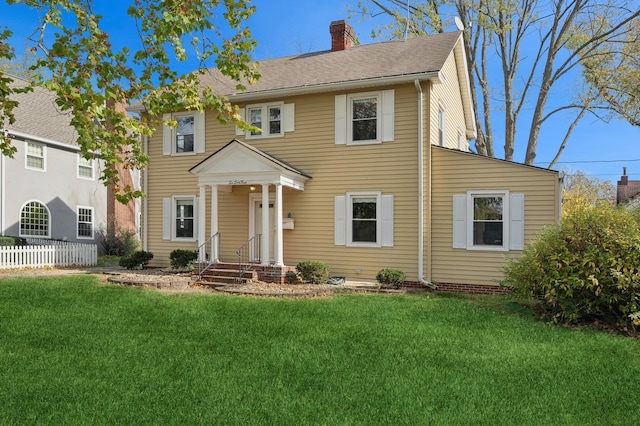 colonial home featuring a front yard