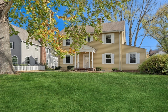 colonial-style house with a front yard